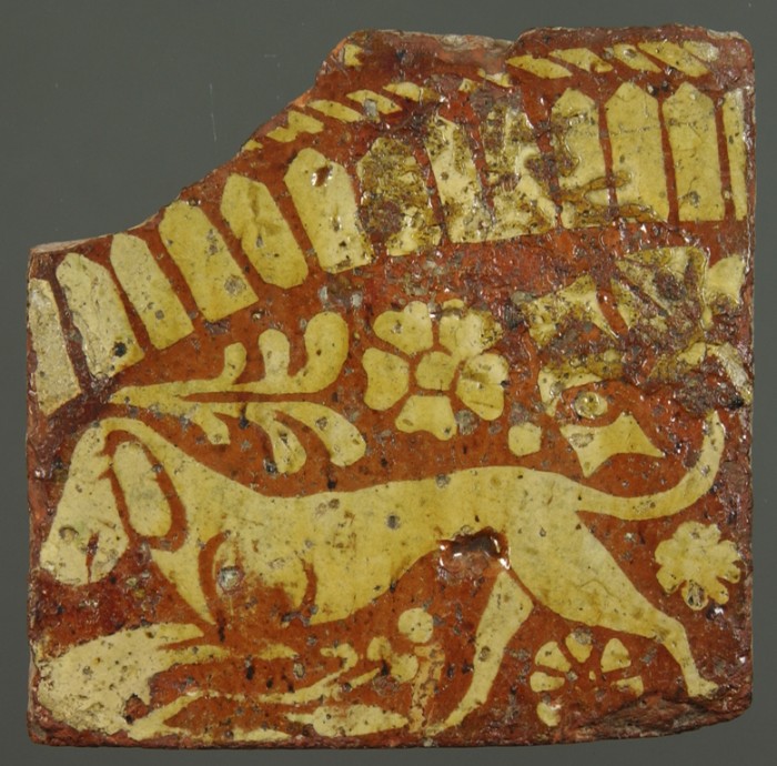 A hound on a decorative floor tile 