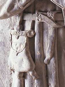 A purse with a metal frame on the effigy of Thomas White at the Church of St Mary, Tenby.